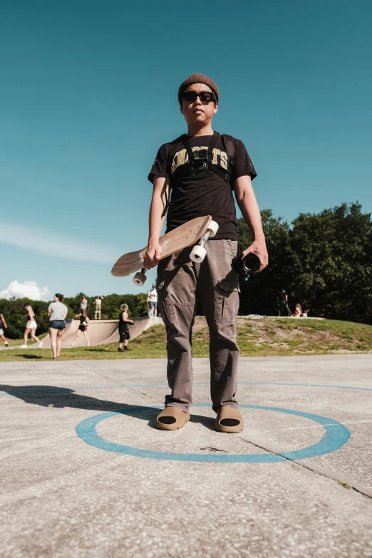 a man with a skateboard on the pavement