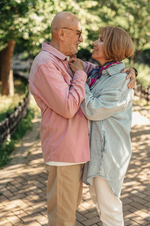 a smiling man and woman emcing while they stand near each other