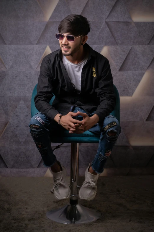 a man sitting on top of a blue chair