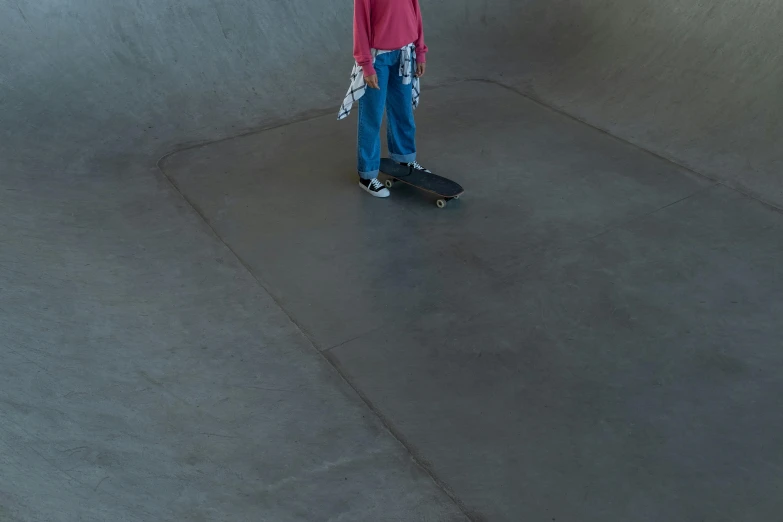 a child is holding onto a skateboard in the street