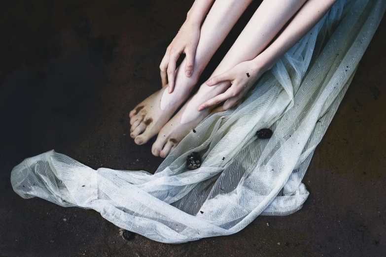 the feet of three people resting on a blanket