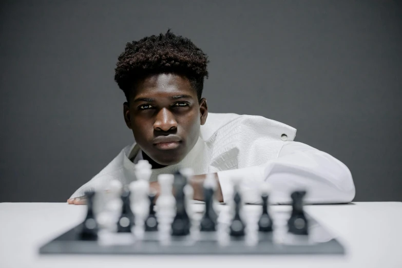 a young man is posing for a po with chess