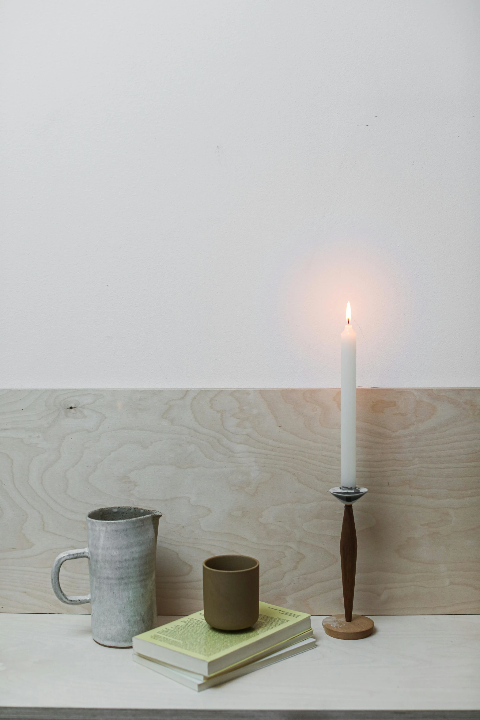 a candle and mug on a table