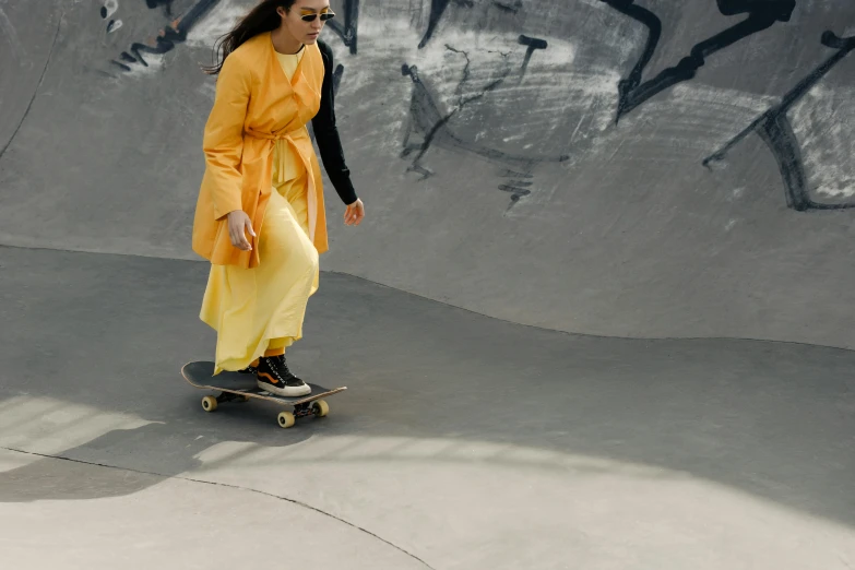 the young woman is on her skateboard at the park