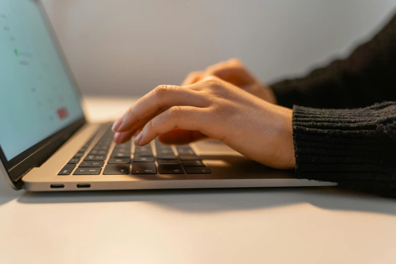 a person is working on their laptop at a table