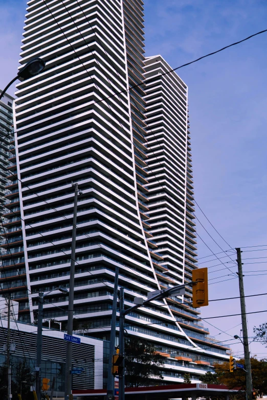 a tall office building stands over some other buildings