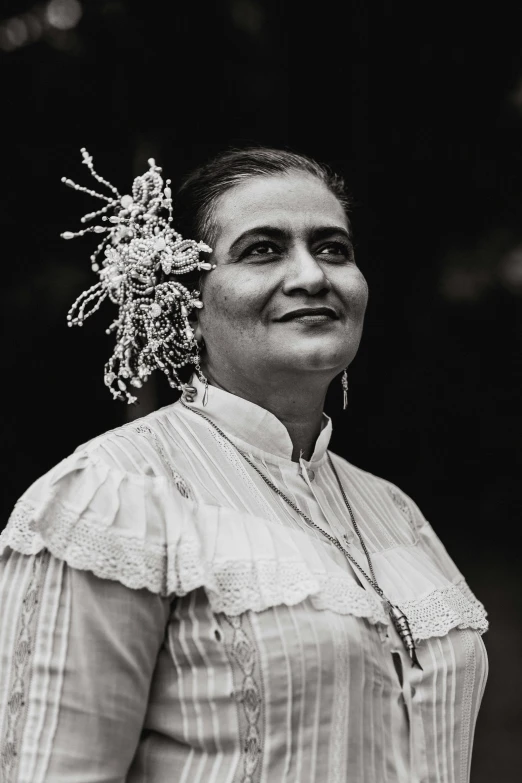 black and white po of woman wearing a frilly top