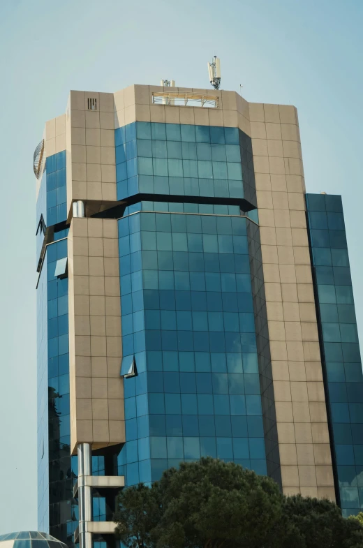 the large office building has blue tile on its windows