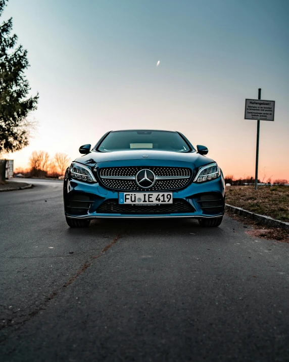 a blue car is parked on the side of the road