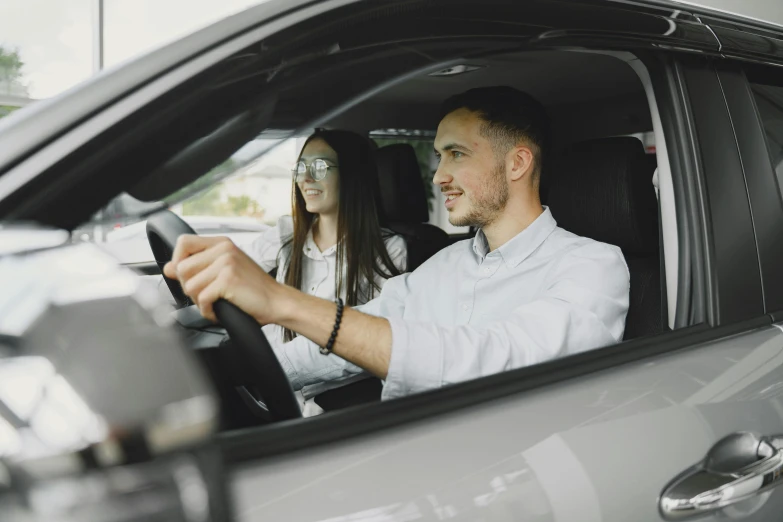 a couple of people inside a car driving down the road