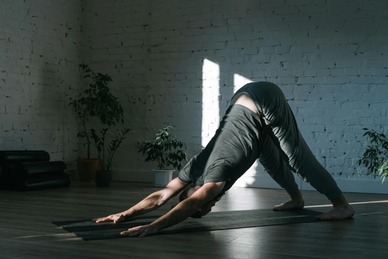 a woman is practicing a yoga position on her mat