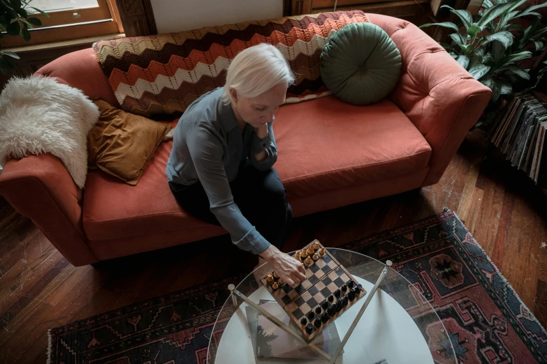 a lady is kneeling down holding a plaid checkered bag