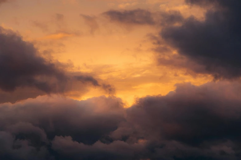 a plane flying through a cloudy sky