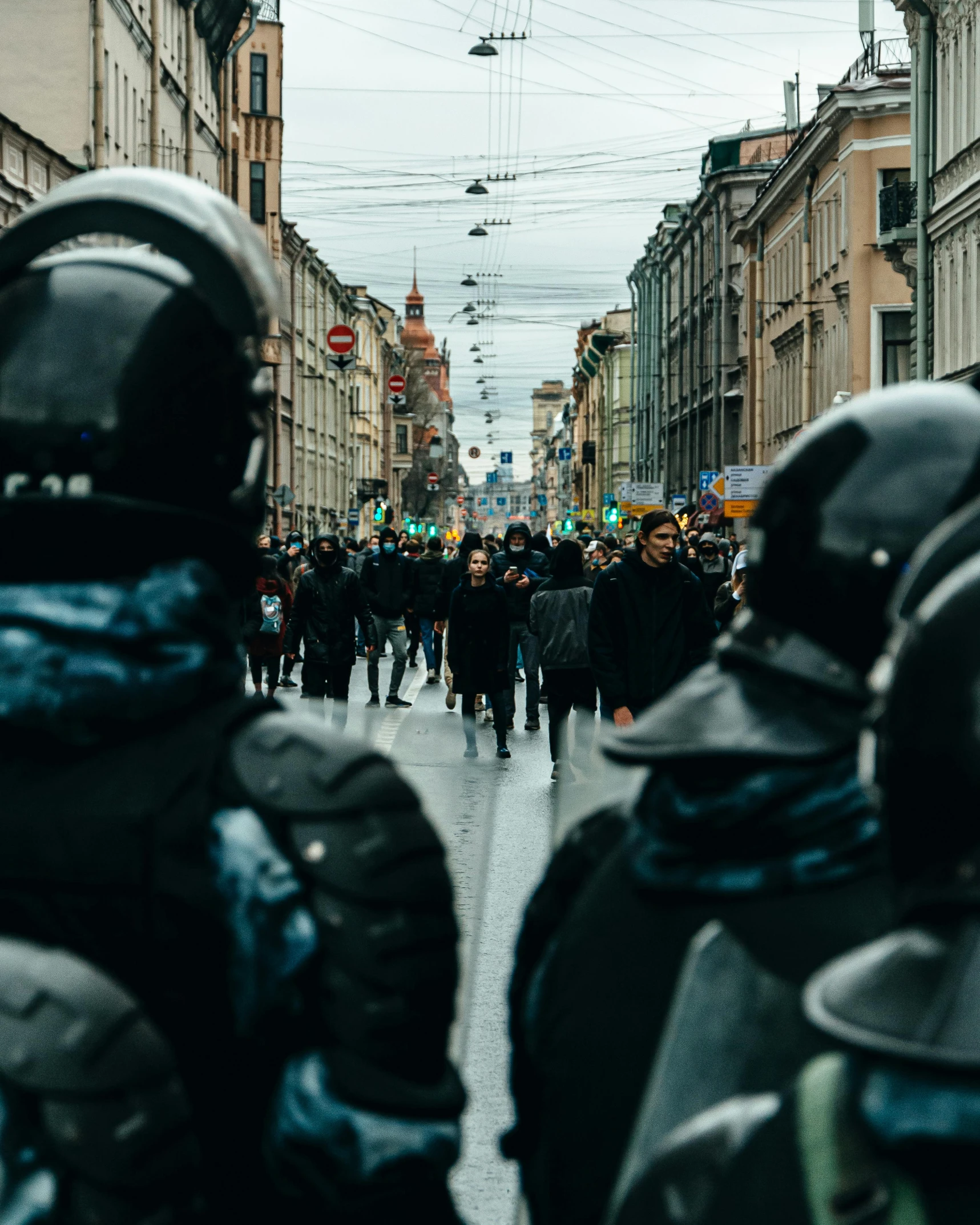 a crowd of people walking down a street near buildings