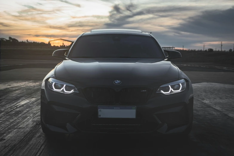 a front view of a bmw cars parked in a parking lot