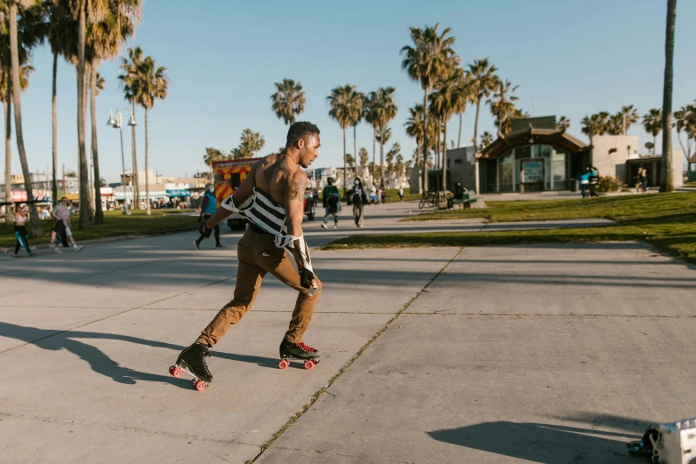 a man riding a skateboard next to palm trees