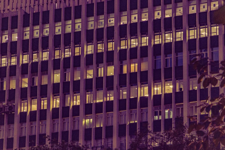 a building with several windows lit up at night