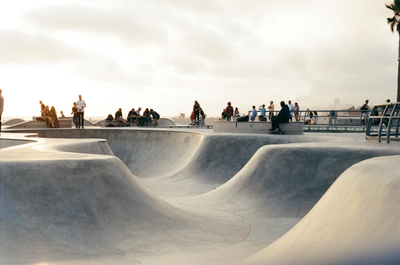 many people on skate boards in a skate park