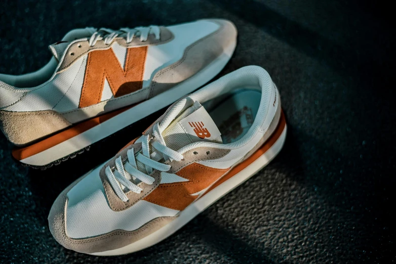 two new balance 997 sneakers sitting on the ground