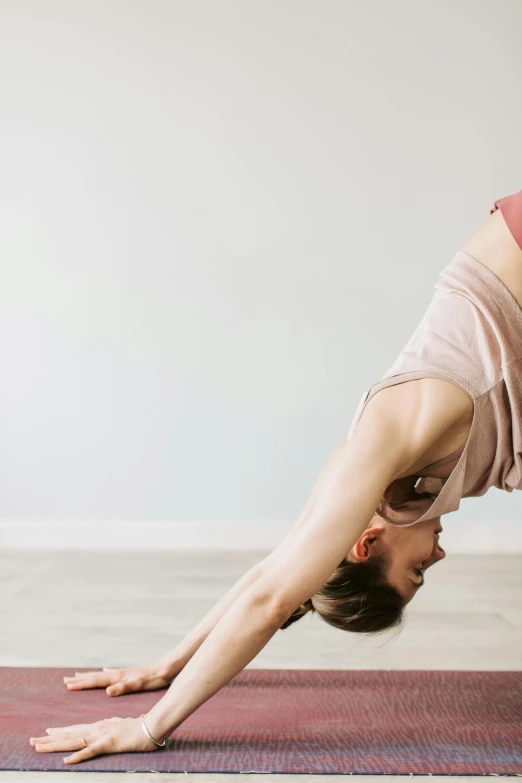 a woman stands in a downward yoga position