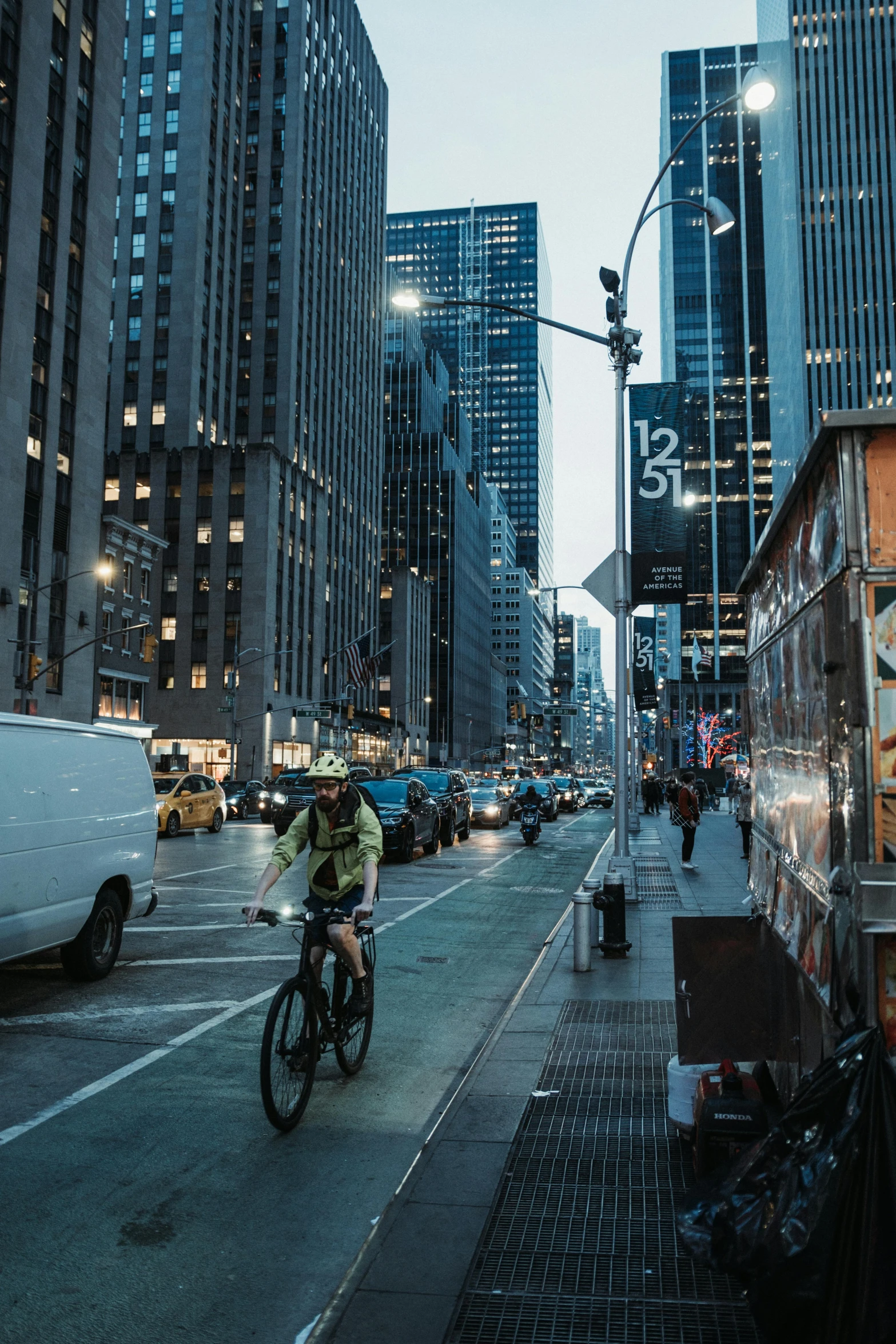 man on bicycle and buildings in the background at night