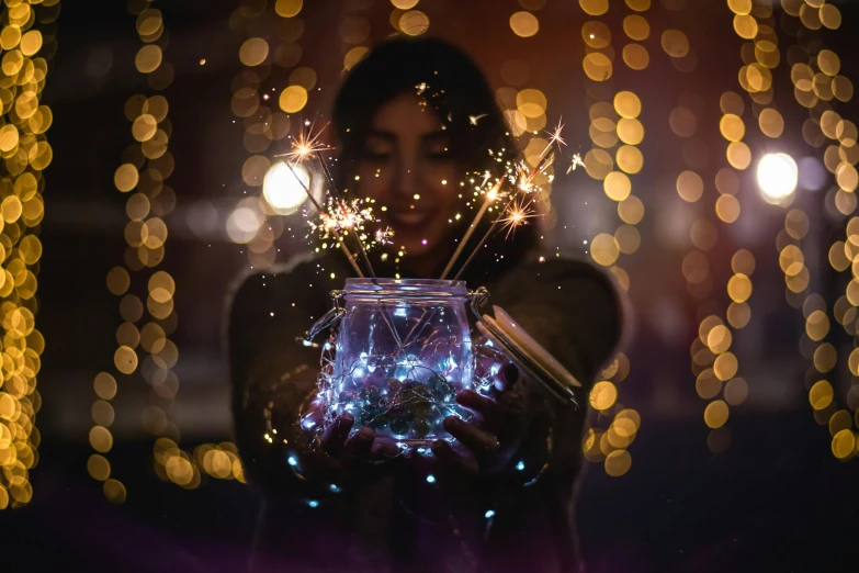 a woman holding a jar with lots of fireworks