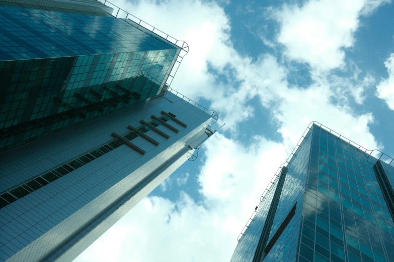 looking up at the glass skyscrs in a business area