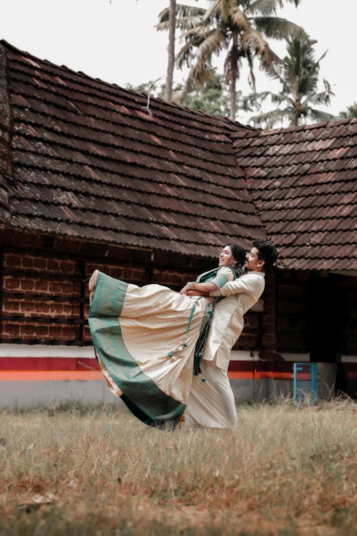 two people are performing a traditional dance in an open field