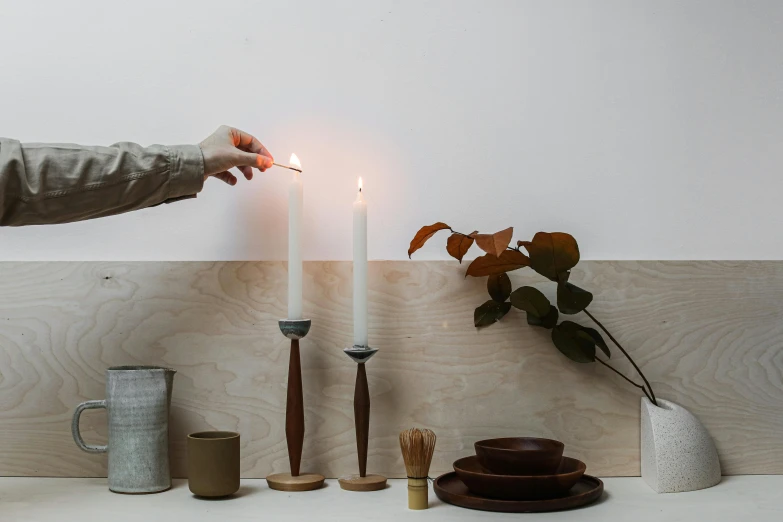 a man that is lighting some kind of candle