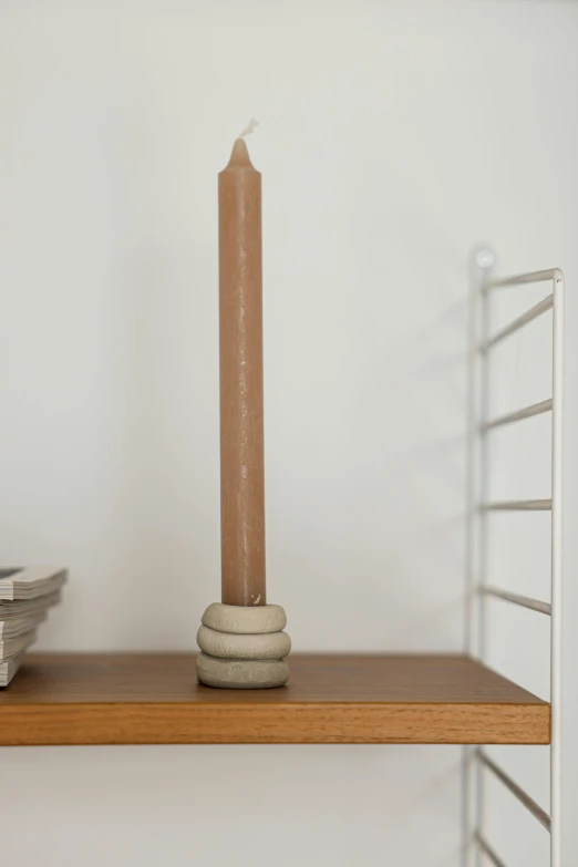 a candle that is sitting on top of a shelf