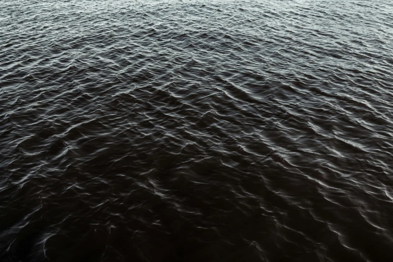 a boat sails across an empty body of water