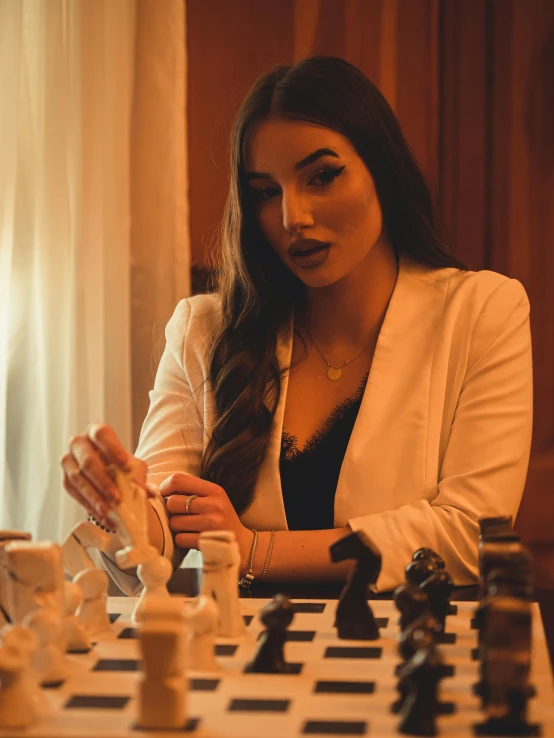 a young woman playing a game of chess