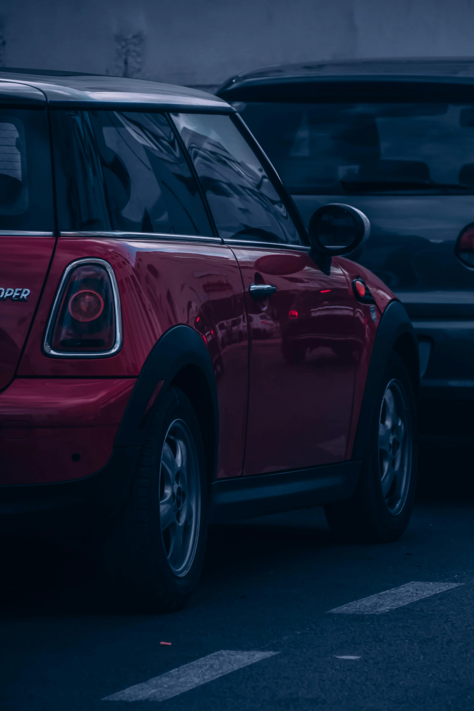 a mini - car is parked in a parking lot at night