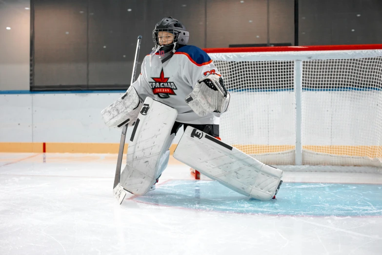 a man in uniform is getting ready to play hockey