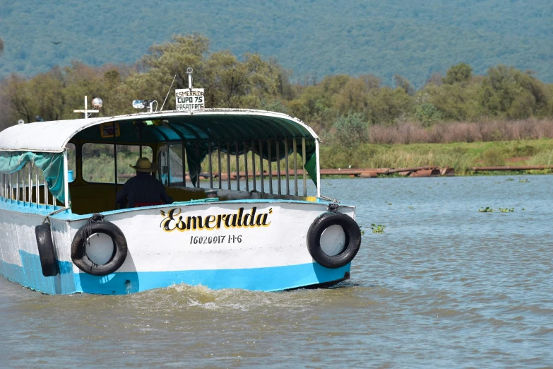 a passenger bus is moving through the water