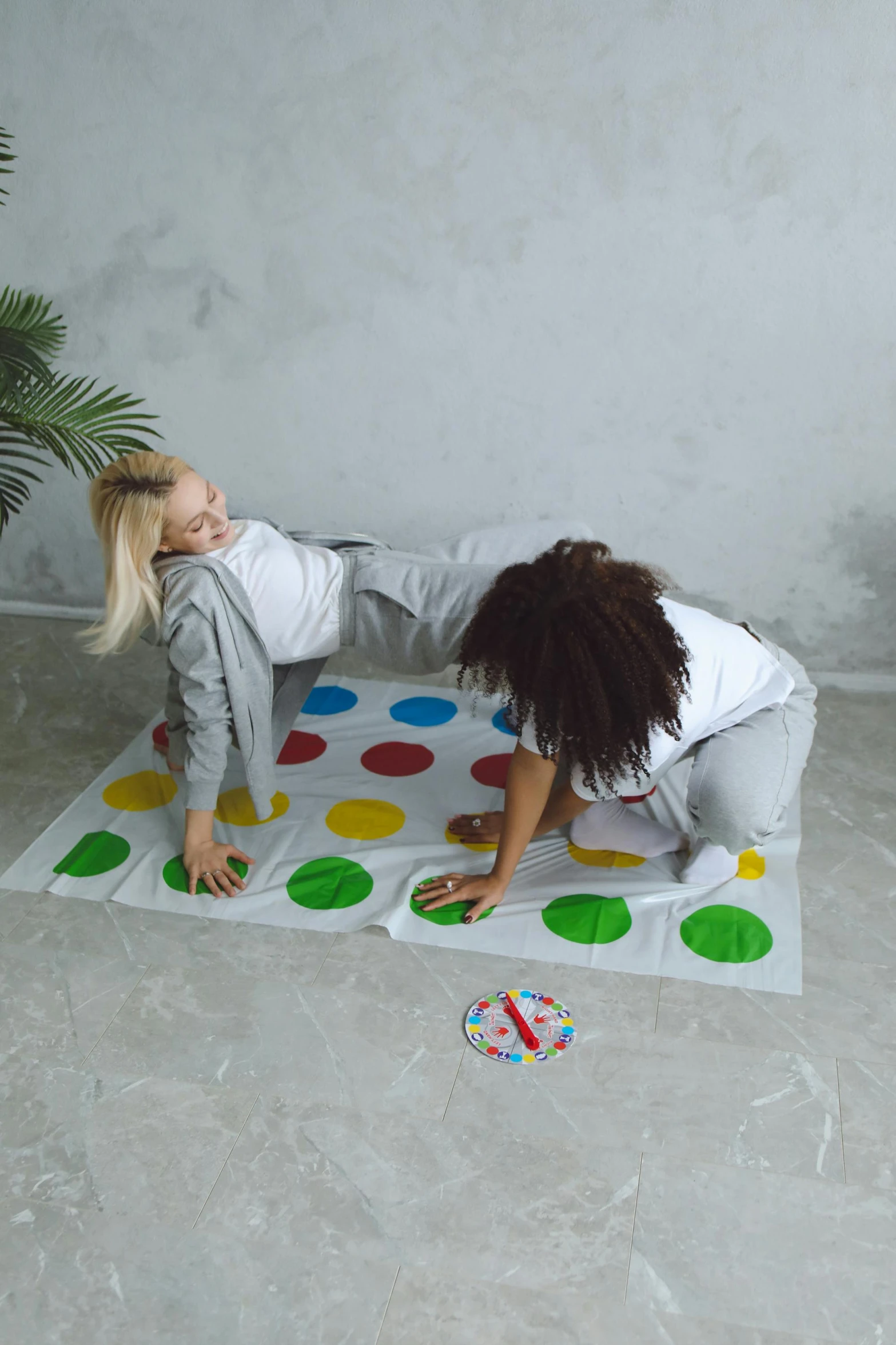 two people are lying down on the ground in a room