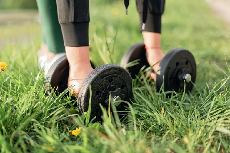 someone standing on two black wheels in the grass