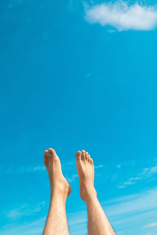 the feet and leg of a man on a beach