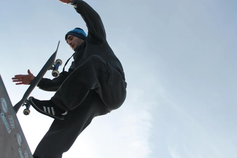 a man with a skate board jumping on a ramp