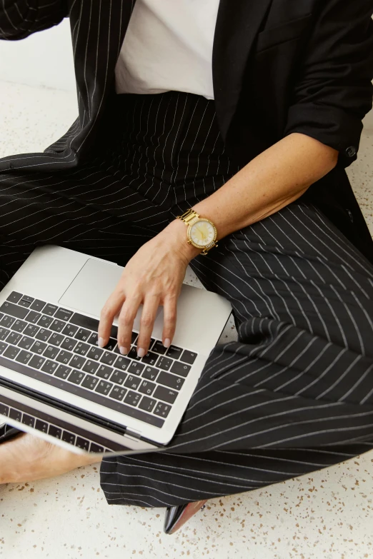 a woman in business clothes on her computer