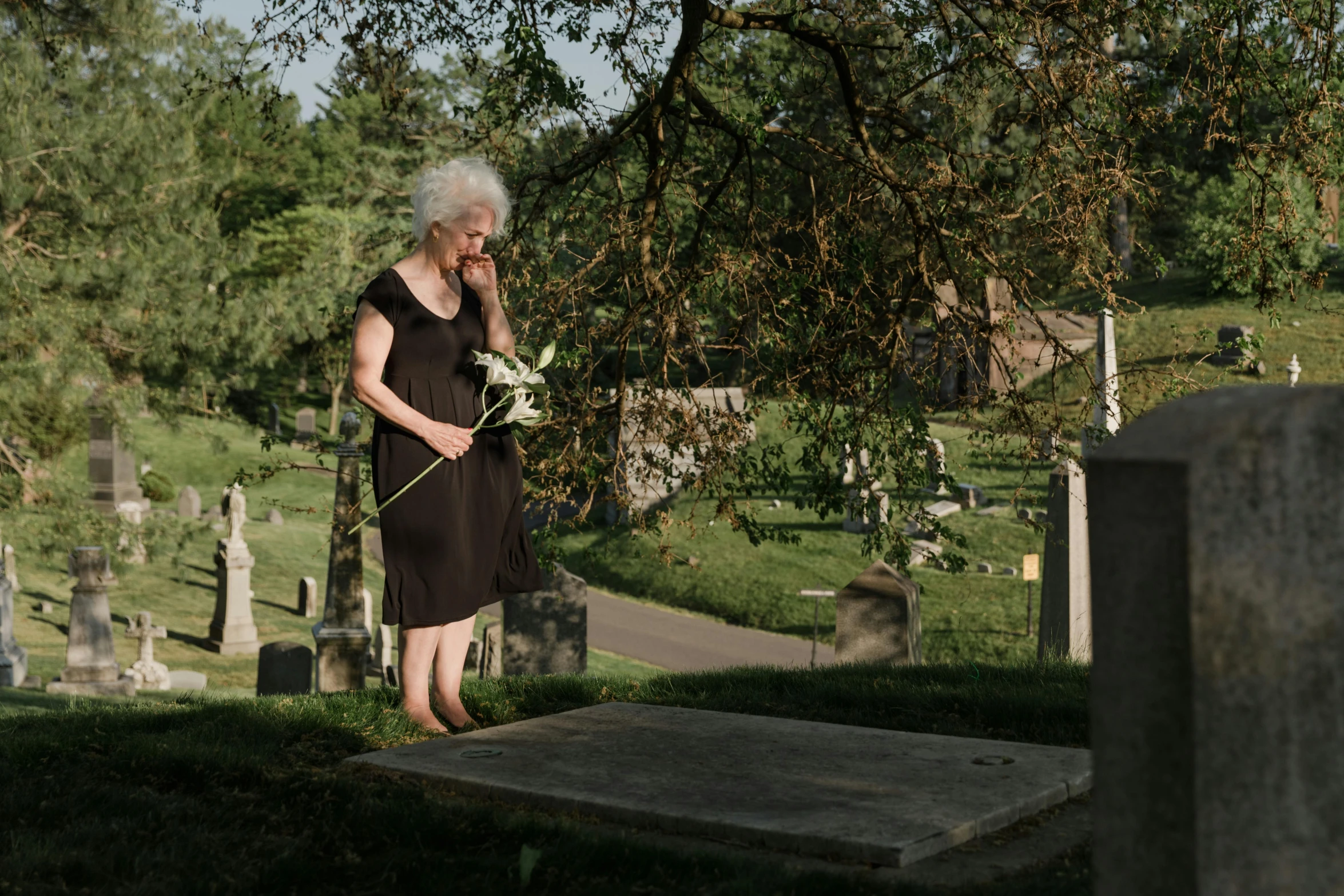 an old woman holding soing in her hand