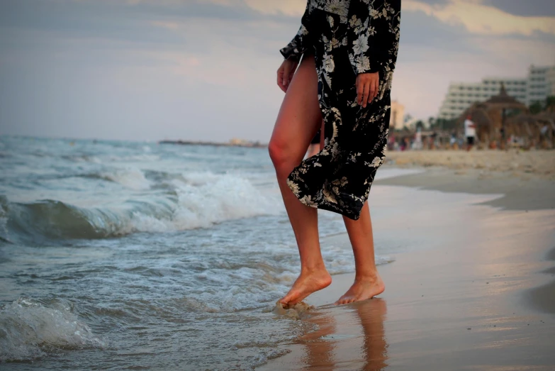 a person standing in the ocean water at the beach