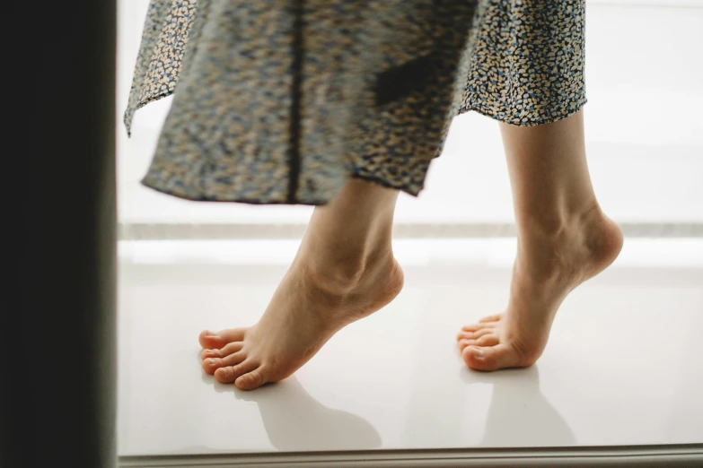 woman standing on top of a platform near a window