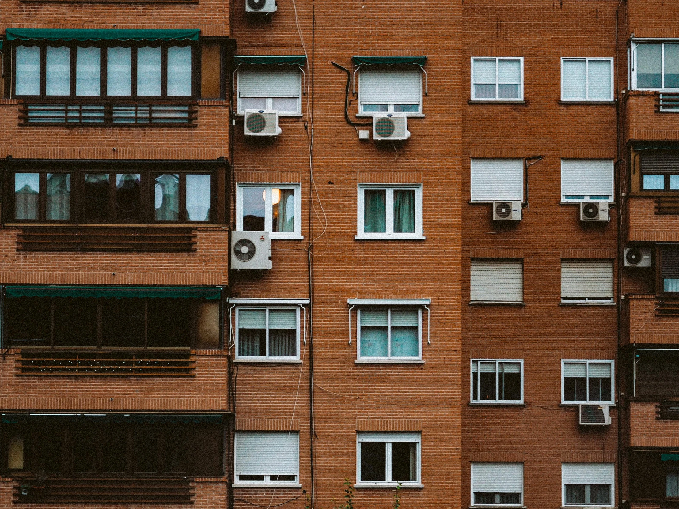 a picture of a tall brick building with window panes