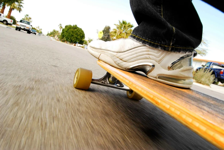 a skateboarder with white and black shoes is riding