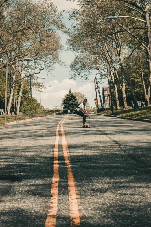 the guy is doing tricks on his skateboard in the street