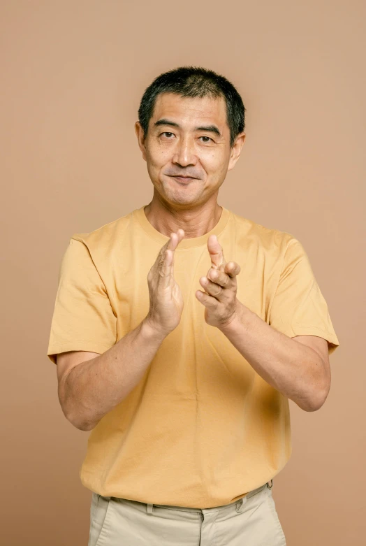 a man holding his hands together and making a hand gesture