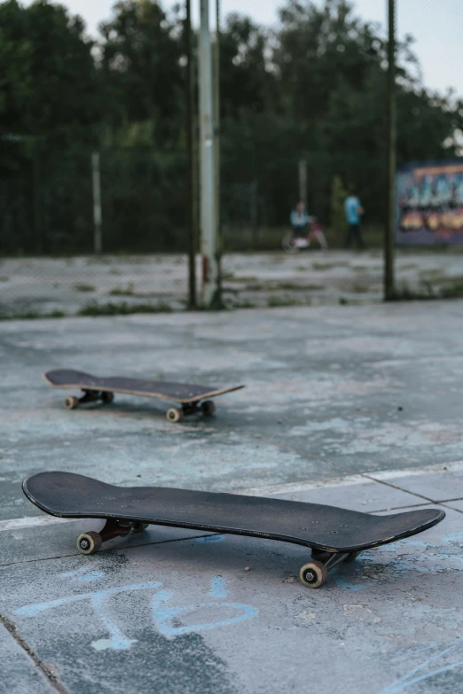 the skateboards are on the ground next to each other