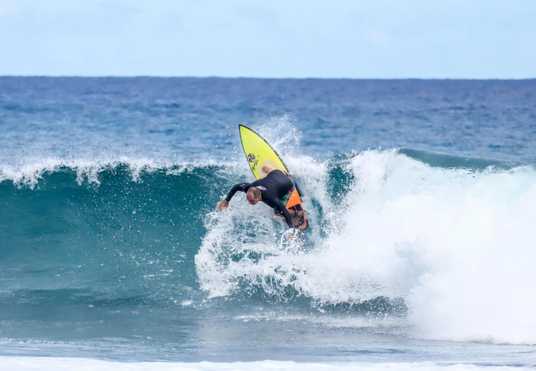 a man on a surfboard riding a wave