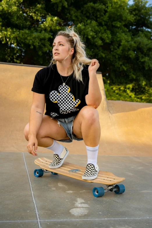 a woman is riding on a skateboard in an empty skating park